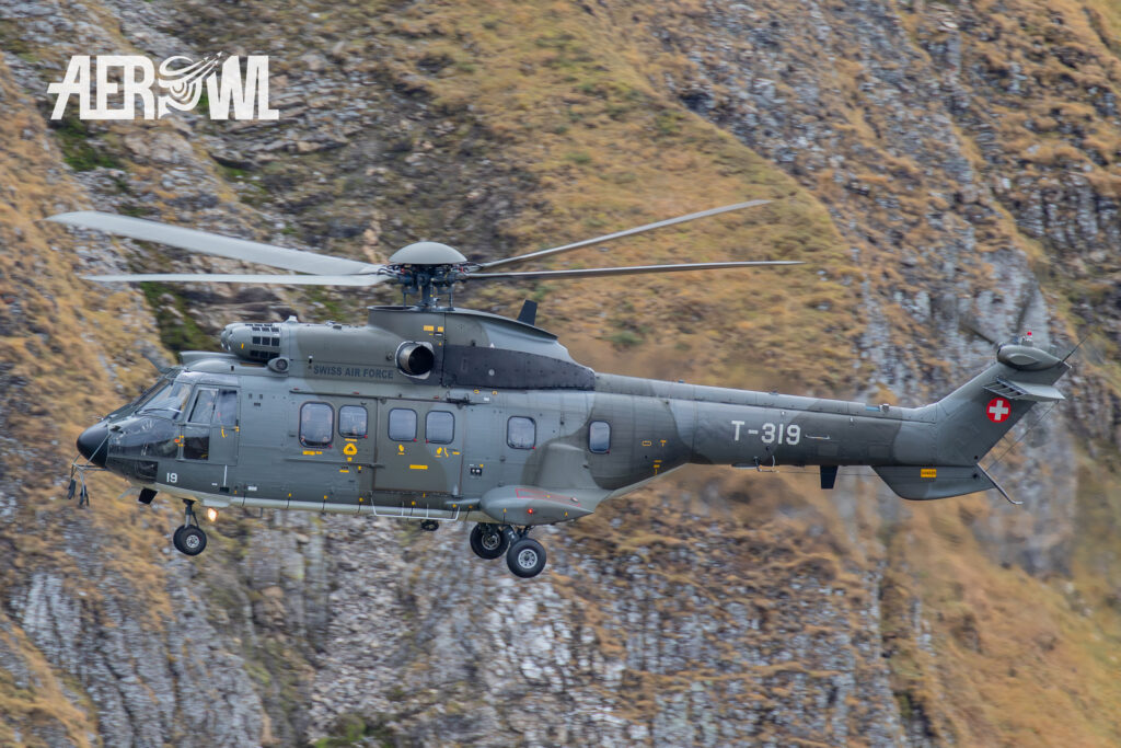 A AS.332M1 Super Puma of the Swiss Air Force brings guests to the Axalp 2018 Fliegerschiessen in the Swiss alps.