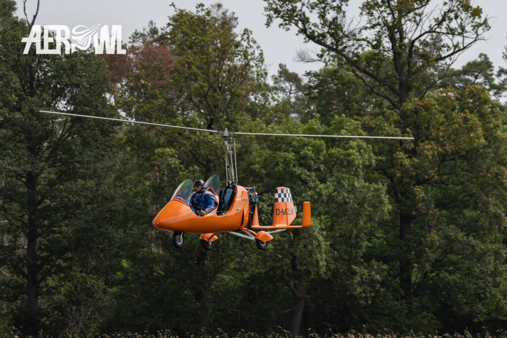 A interesting looking orange colored AutoGyro MTO Sport (D-MZLW) landing at the Bienenfarm airport near Berlin during Stearman&Friends 2023.