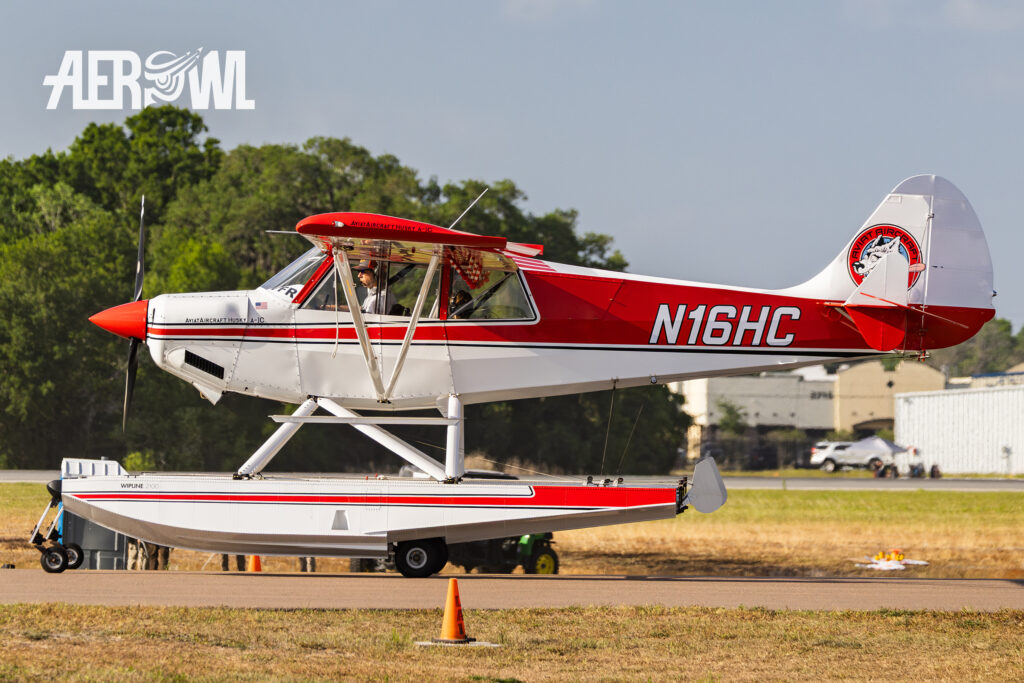A classic red and white painted Aviat Husky A-1C-200 taxiing towards the runway during Sun'n Fun 2025 in Lakeland, Florida.