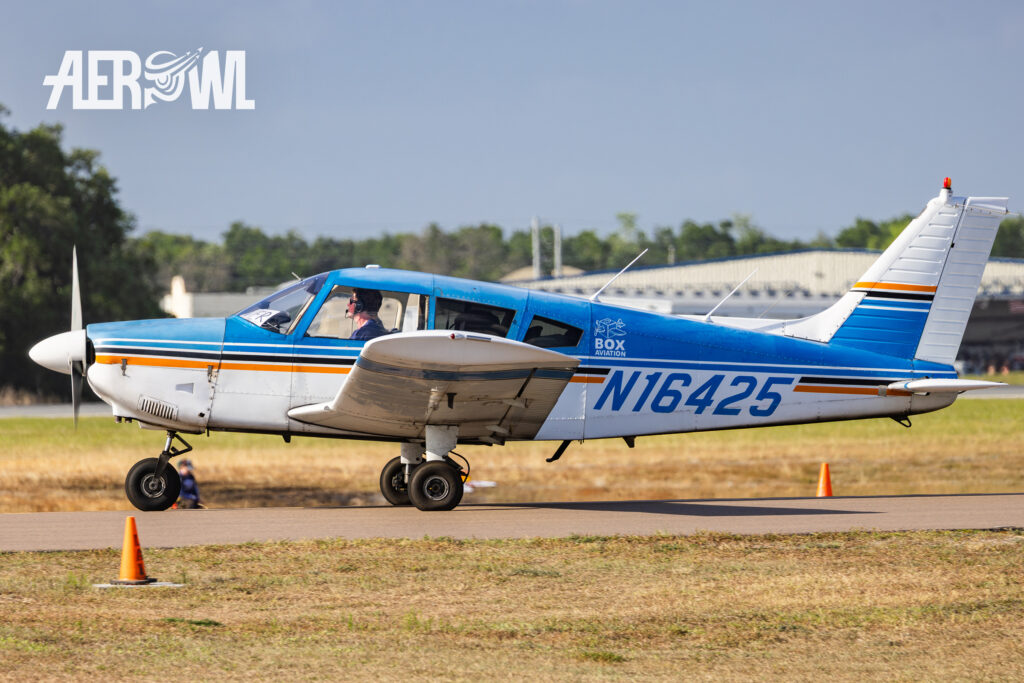 A blue and white painted 1973 Piper PA-28-180 Cherokee rolling the runway towards to its startpoint at the Sun'n Fun 2025 in Lakeland, Florida,