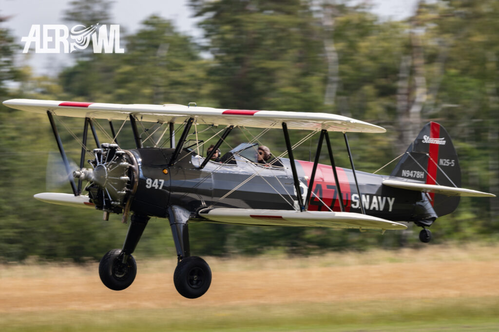 A great black, red and white colored Boeing B75N1 Stearman during its approach at the Stearman&Friends2023 over the Bienenfarm near Berlin, Germany.
