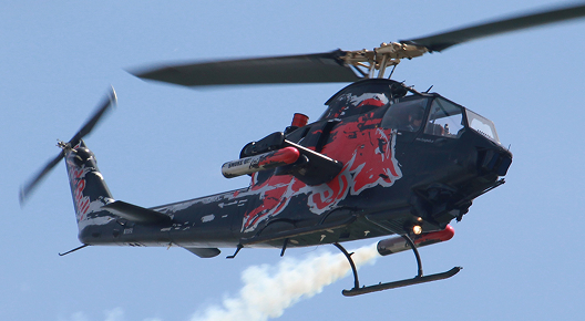 The Red Bull Bell Cobra 209/AH-1F during an air display at the ILA 2014 on the BER airport Berlin-Brandenburg in Germany.