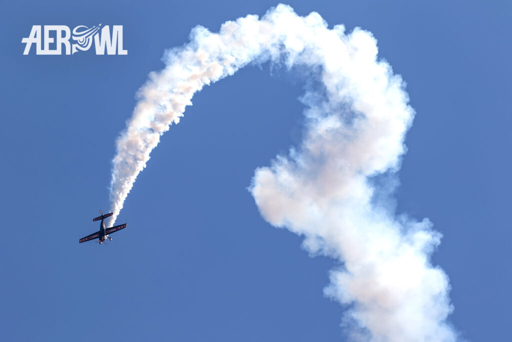 Extra 300L - peak dive with a lot of smoke. Stunning pilot skills over the BER airport Berlin/Brandenburg during the ILA 2018 in Germany.