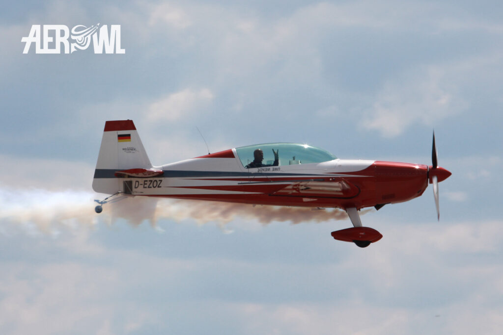 A red & white Extra 300L piloted by Uwe Wendt starts to its aerobatics air display during the ILA 2014 at the BER airport Berlin/Brandenburg in Germany.