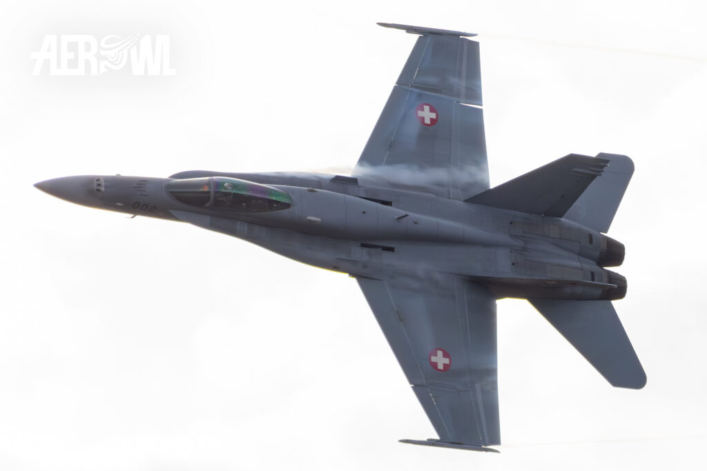 A Boeing F/A-18C Hornet of the Swiss Air Force flies a vaping hard turn during the Axalp Fliegerschiessen 2023 in the Swiss Alps.