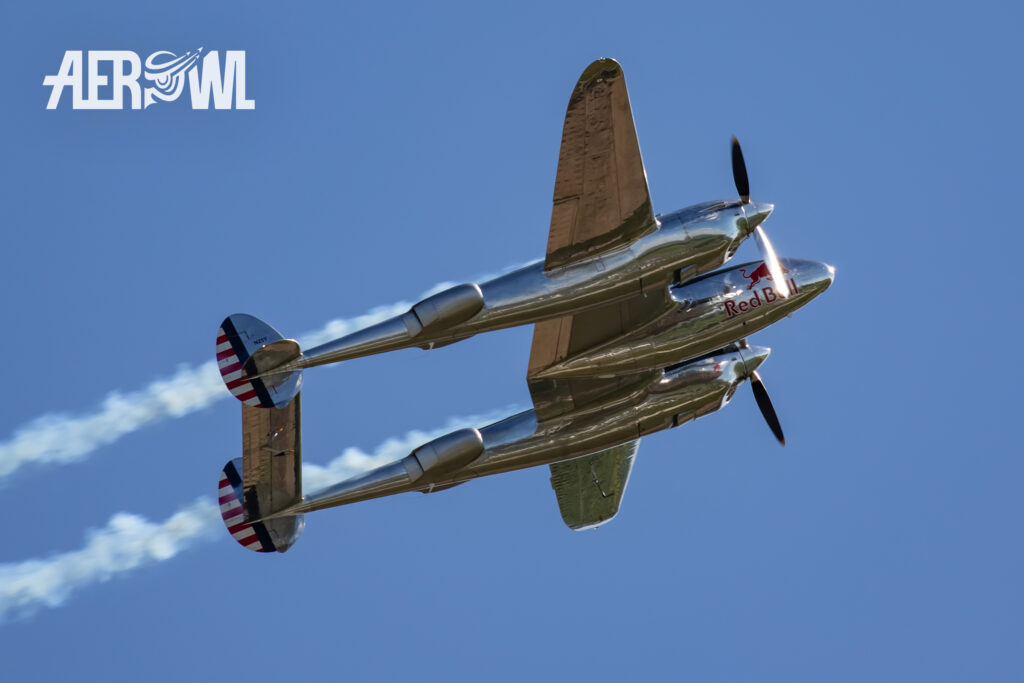 Smoke on for a climbing Lockheed P-38 Lightning over the ILA 2014 audience at the BER airport Berlin-Brandenburg in Germany.