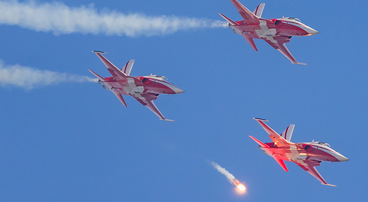 Patrouille Suisse in their Northrop F-5E Tiger II dropping flares during the Axalp 2022 airshow in the Swiss mountains.
