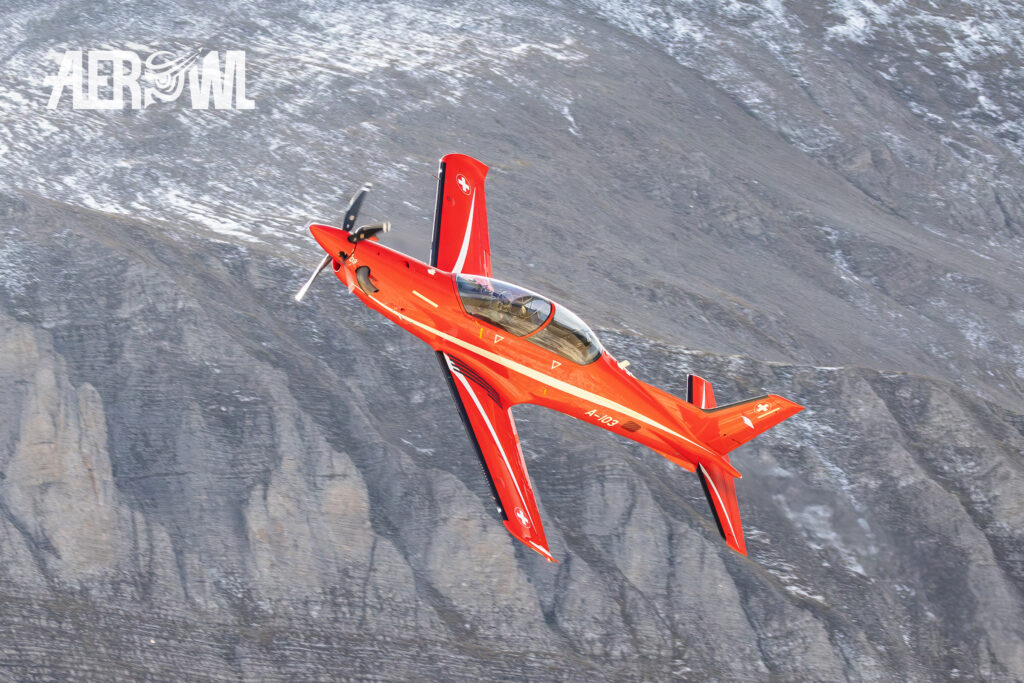 A red Swiss Airforce trainer Pilatus PC-21 shows up during the Axalp 2023 in the Swiss alps.
