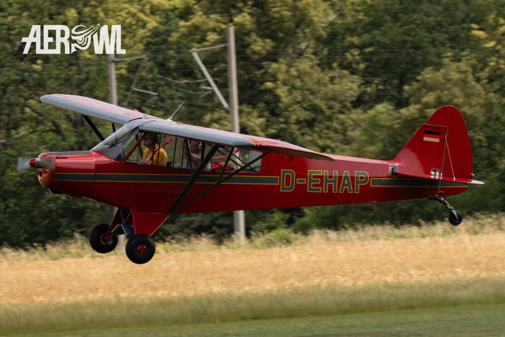 A famous red Piper PA-18-95 Super Cub (D-EHAP (QUAX Flieger) landing during the Stearman&Friends2023 at the Bienenfarm airport near to Berlin.