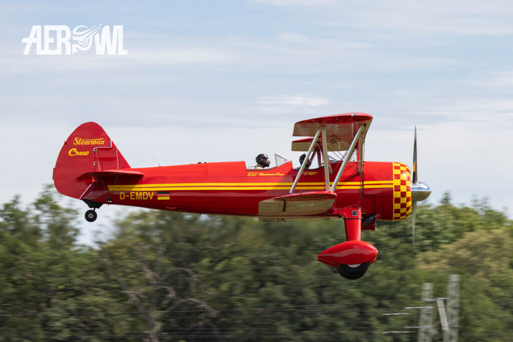 A red painted Boeing-Stearman E75 from 1941 starting during the Stearman&Friends 2024 at the Bienenfarm near Berlin, Germany.